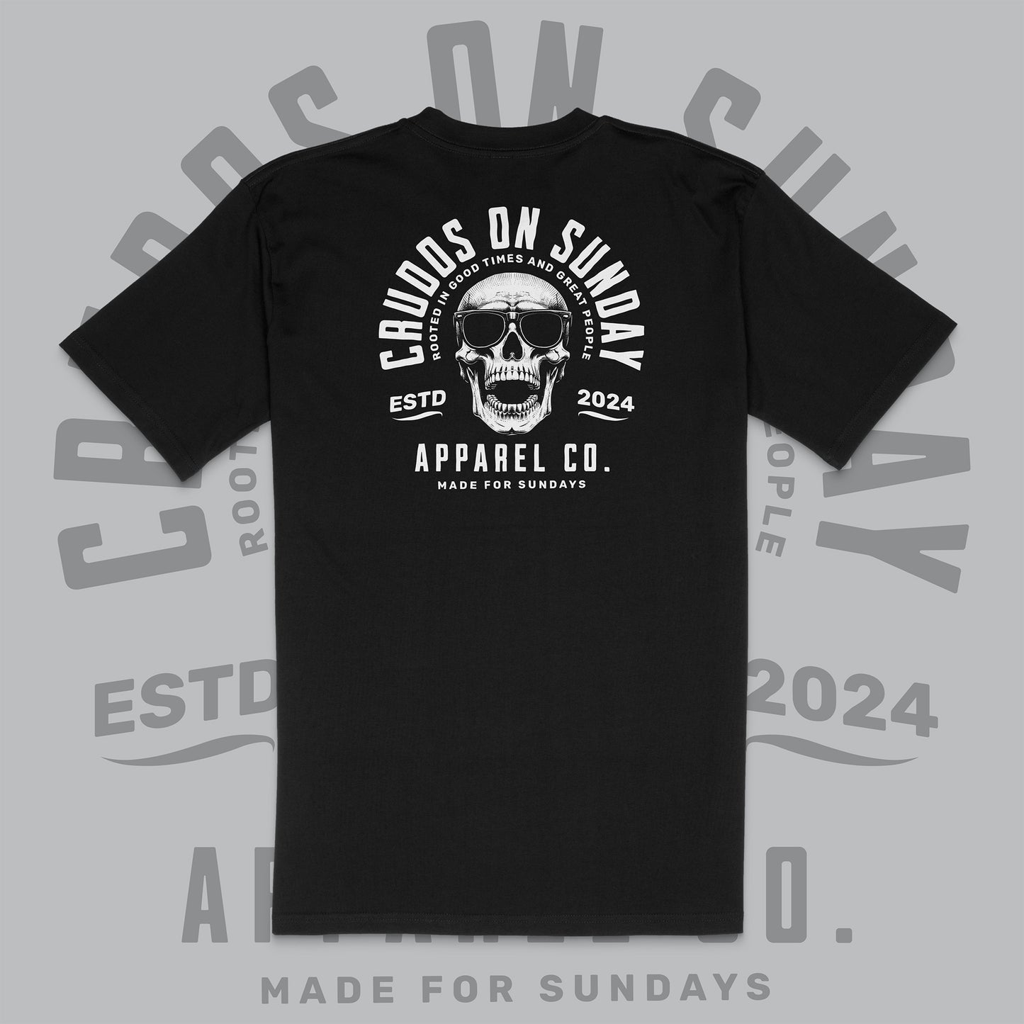 Black t-shirt with skull graphic and text on a gray background