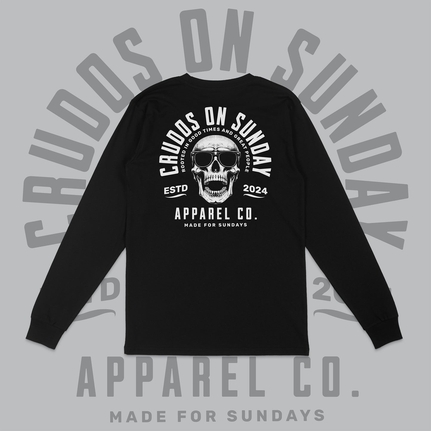 Black long-sleeve shirt with skull design and text on a gray background